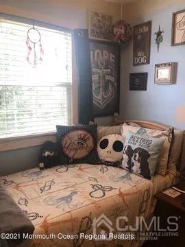 80 Greenwood Loop Road, Unit 80 Brick, NJ 08724 - Photo 30 of 38 a bedroom with a bed and a window