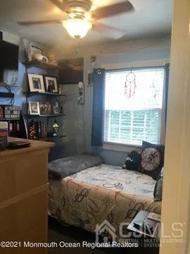 80 Greenwood Loop Road, Unit 80 Brick, NJ 08724 - Photo 32 of 38 a bedroom with a bed and a window