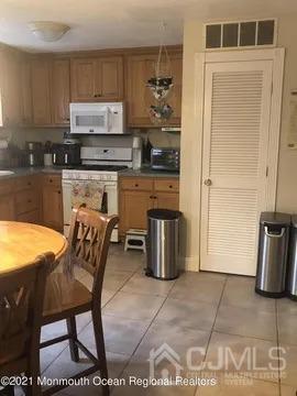 80 Greenwood Loop Road, Unit 80 Brick, NJ 08724 - Photo 8 of 38 a kitchen with stainless steel appliances granite countertop a stove a sink and a refrigerator
