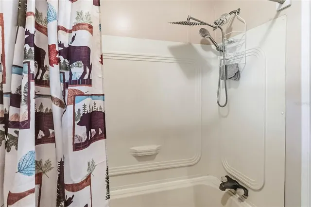 a bathroom with a bathtub and shower