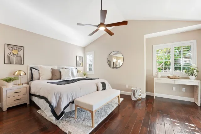 a bedroom with bed and a large window