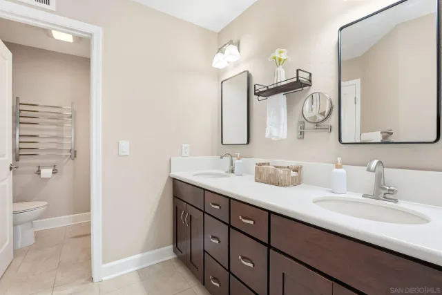 a bathroom with a double vanity sink and a mirror