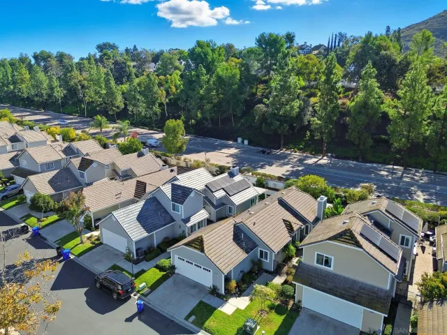 an aerial view of a house with yard swimming pool and outdoor seating