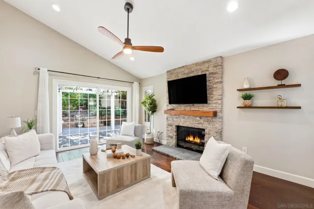 a living room with furniture flat screen tv and a fireplace