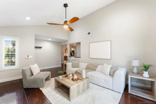 a living room with furniture and wooden floor