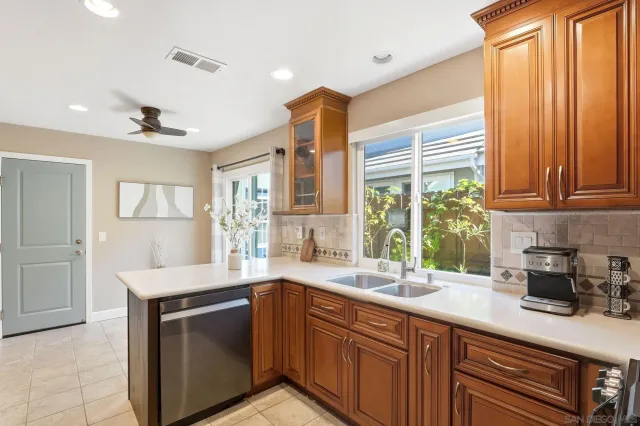 a kitchen with stainless steel appliances granite countertop a sink a stove and a microwave