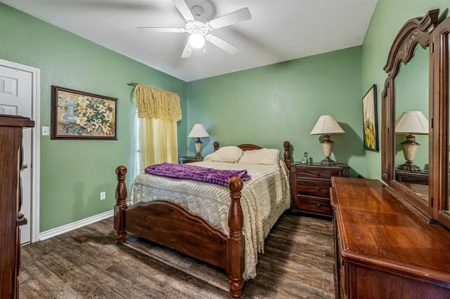 a bathroom with a granite countertop sink a toilet a mirror and bathtub