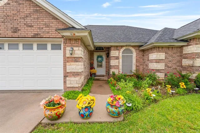 a front view of a house with garden