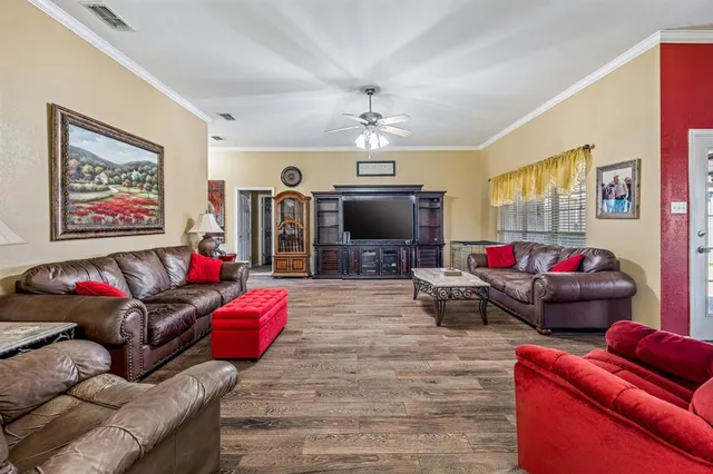 a living room with furniture a flat screen tv and a couch