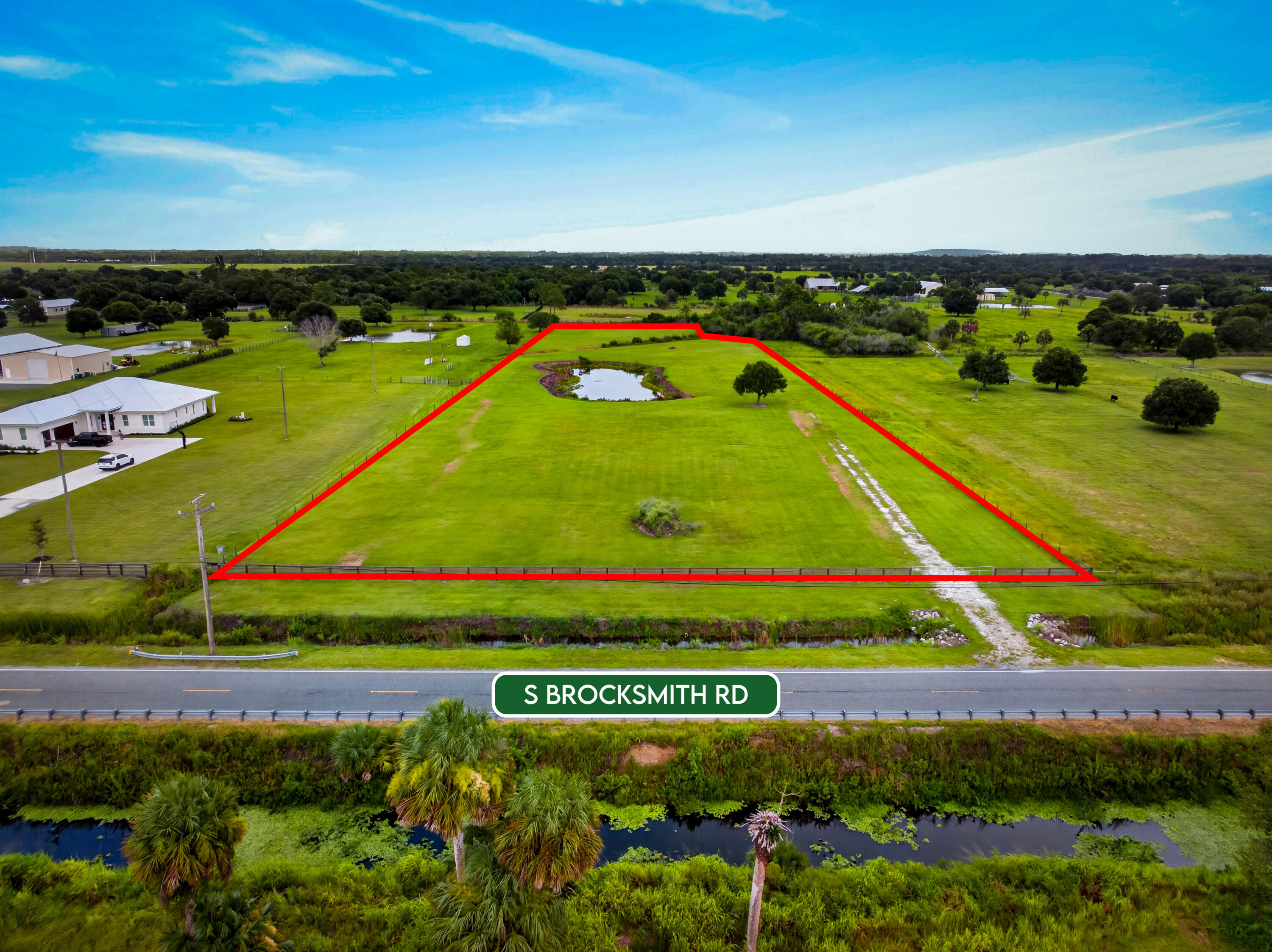 0 South Brocksmith Road Fort Pierce, FL 34945 - Photo 2 of 26 an aerial view of a tennis ground and large trees