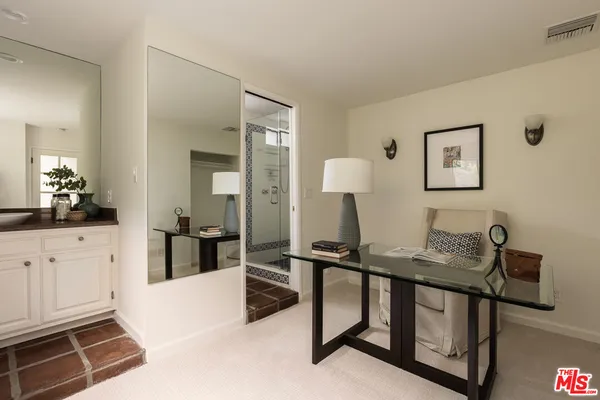 a bedroom with furniture and a flat screen tv