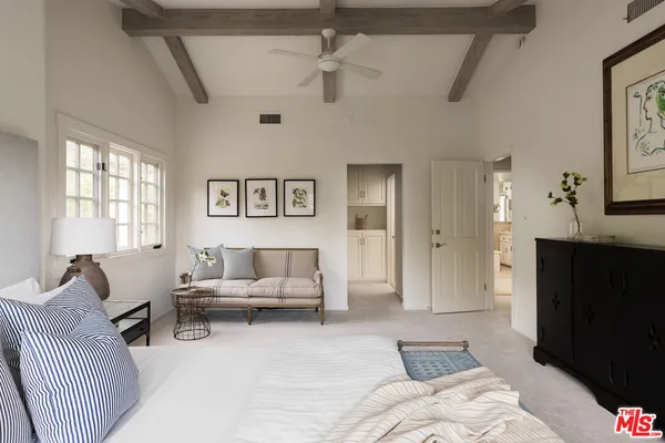 a living room with furniture and painting on the wall