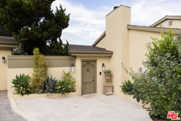 a front view of a house with garden