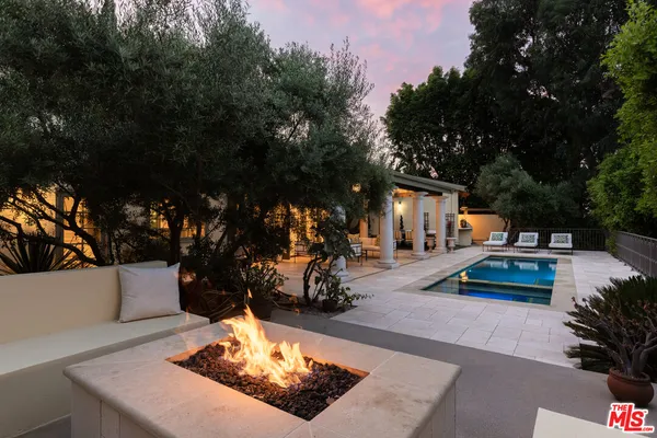 a sink with granite countertop a barbecue grill and wooden floor