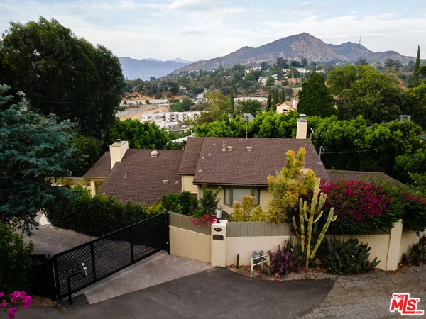an aerial view of house with yard and outdoor seating