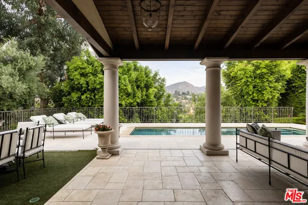 a building outdoor space with patio furniture and potted plants