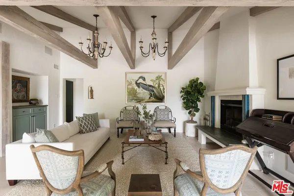 a living room with furniture a fireplace and a table