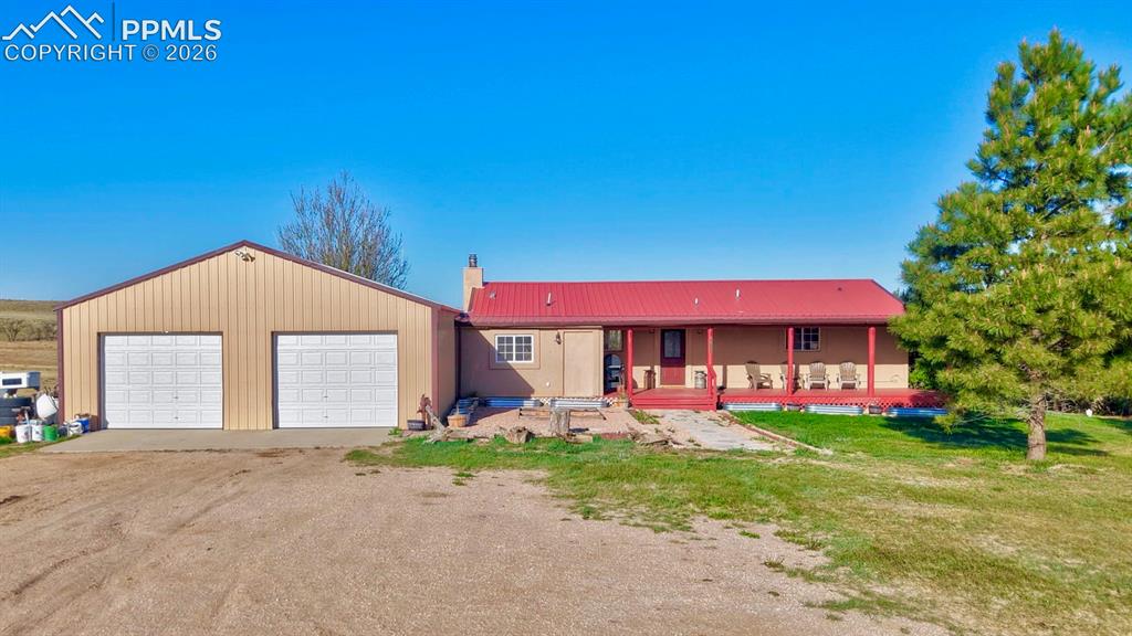 18560 Chelton Road Ramah, CO 80832 - Photo 2 of 34 a backyard of a house with yard and outdoor seating