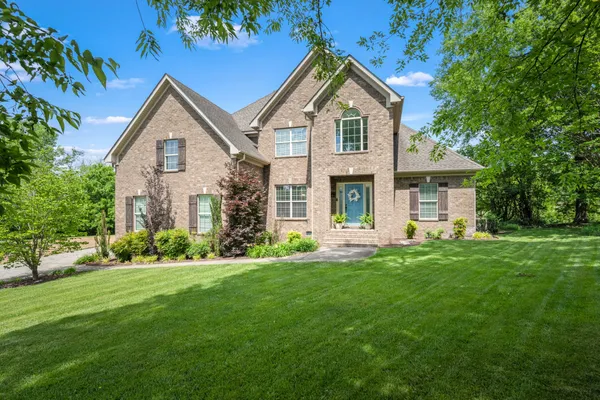 a front view of a house with a yard