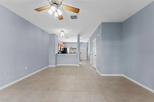 a view of a kitchen with a sink and a chandelier fan