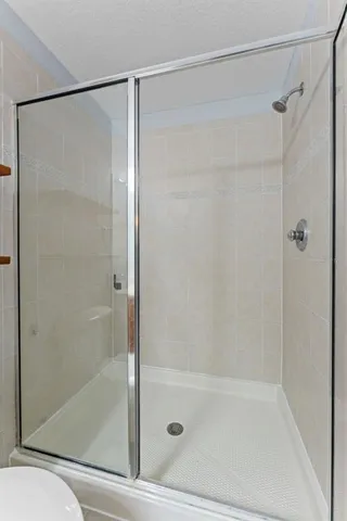 a bathroom with a glass shower door