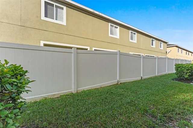 a backyard of a house with wooden fence