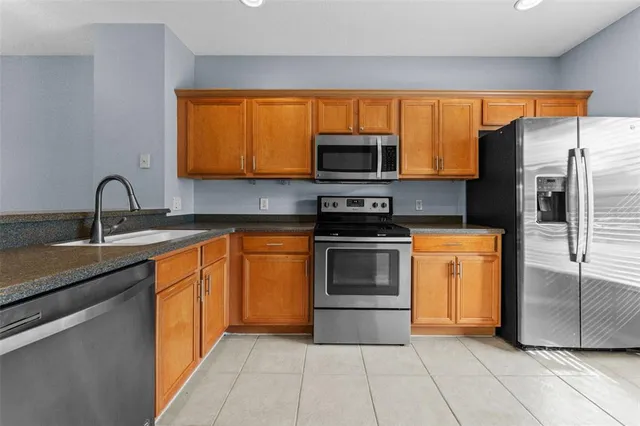 a kitchen with stainless steel appliances a stove sink and microwave