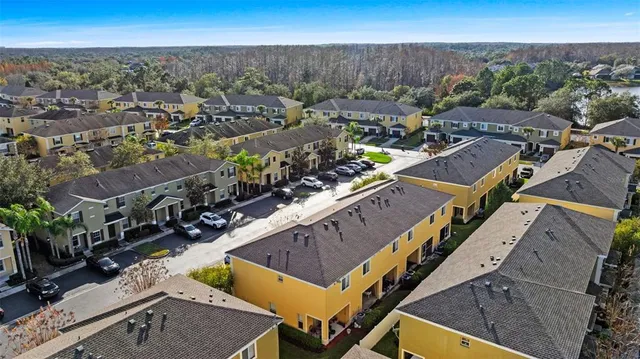 an aerial view of a house with a yard and a fountain