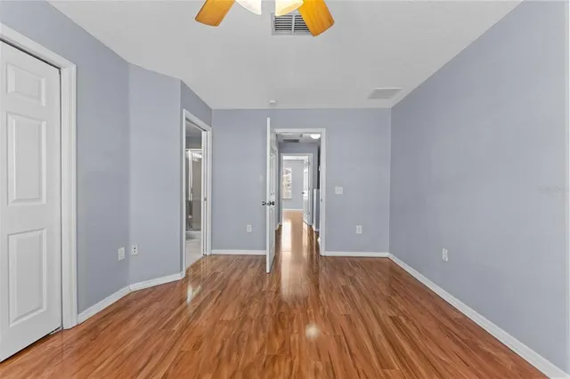 a view of an empty room with wooden floor