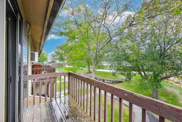 a view of a balcony with wooden floor
