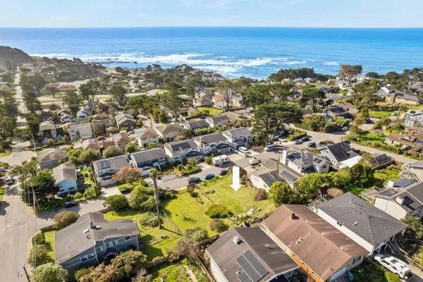 an aerial view of residential building with parking