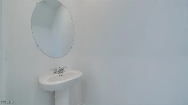a bathroom with a sink a mirror and a toilet