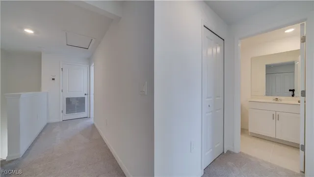 a view of bathroom with sink mirror and window