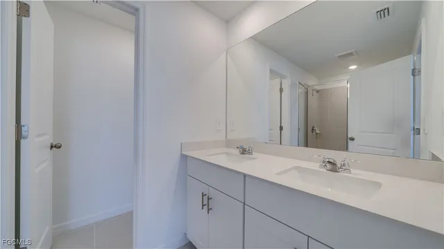 a bathroom with a double vanity sink and a mirror