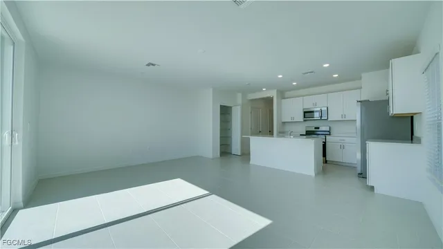 a view of kitchen with white cabinets
