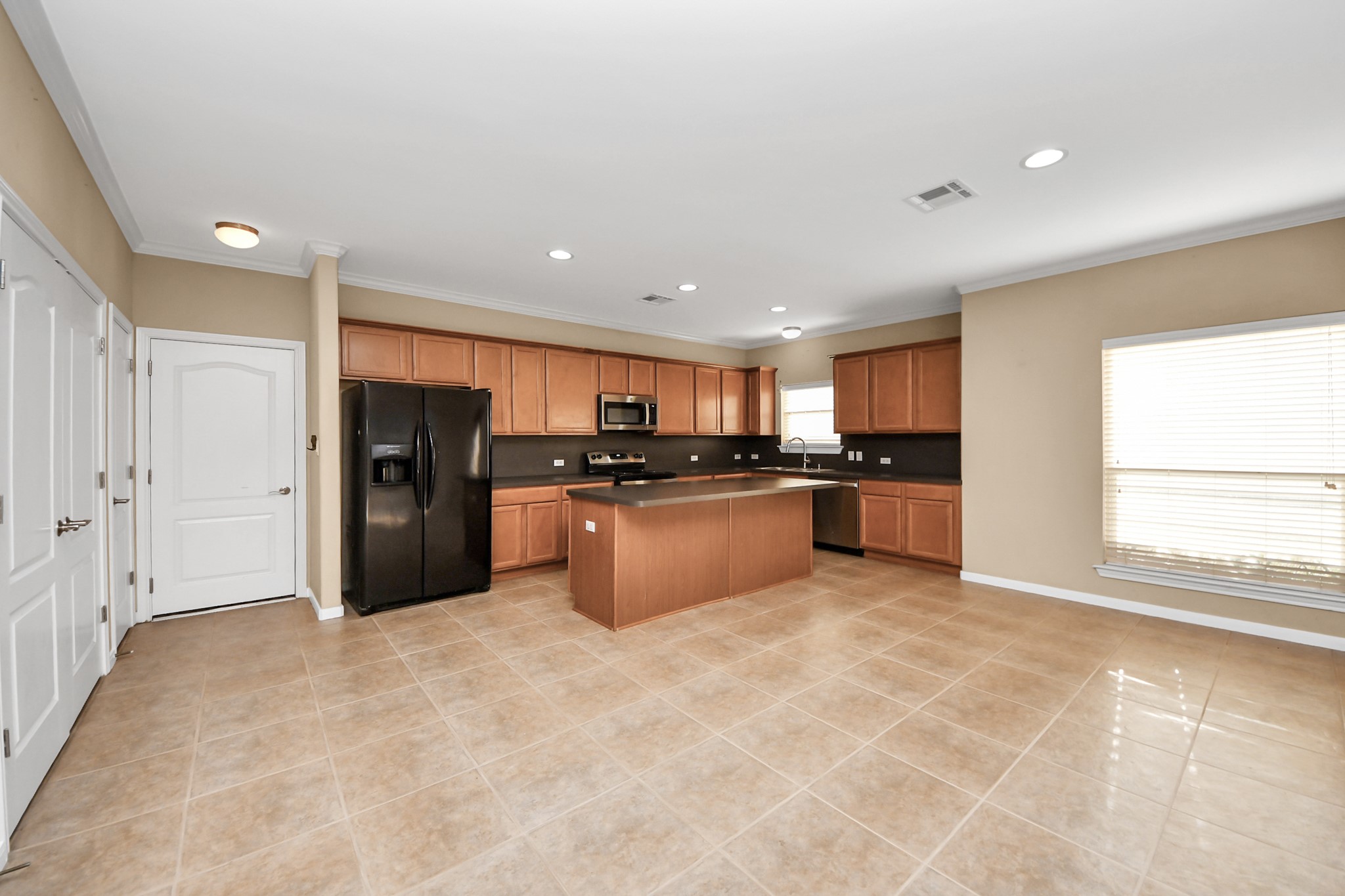 1733 Eagle Lake Road Sealy, TX 77474 - Photo 9 of 34 a large kitchen with stainless steel appliances granite countertop a refrigerator and a sink