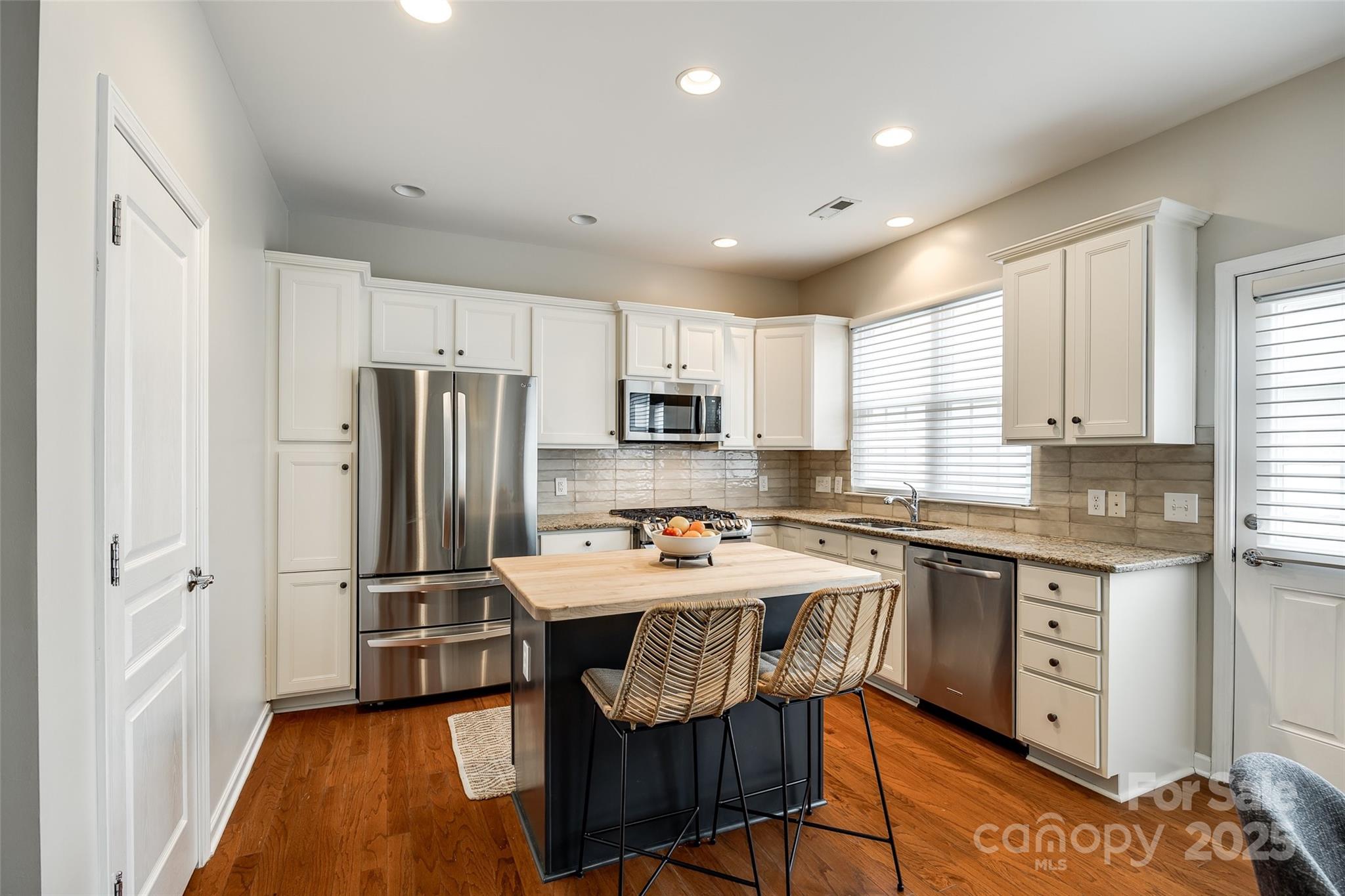 815 Granby Drive Fort Mill, SC 29708 - Photo 11 of 30 a kitchen with stainless steel appliances a refrigerator a sink a stove a microwave and cabinets