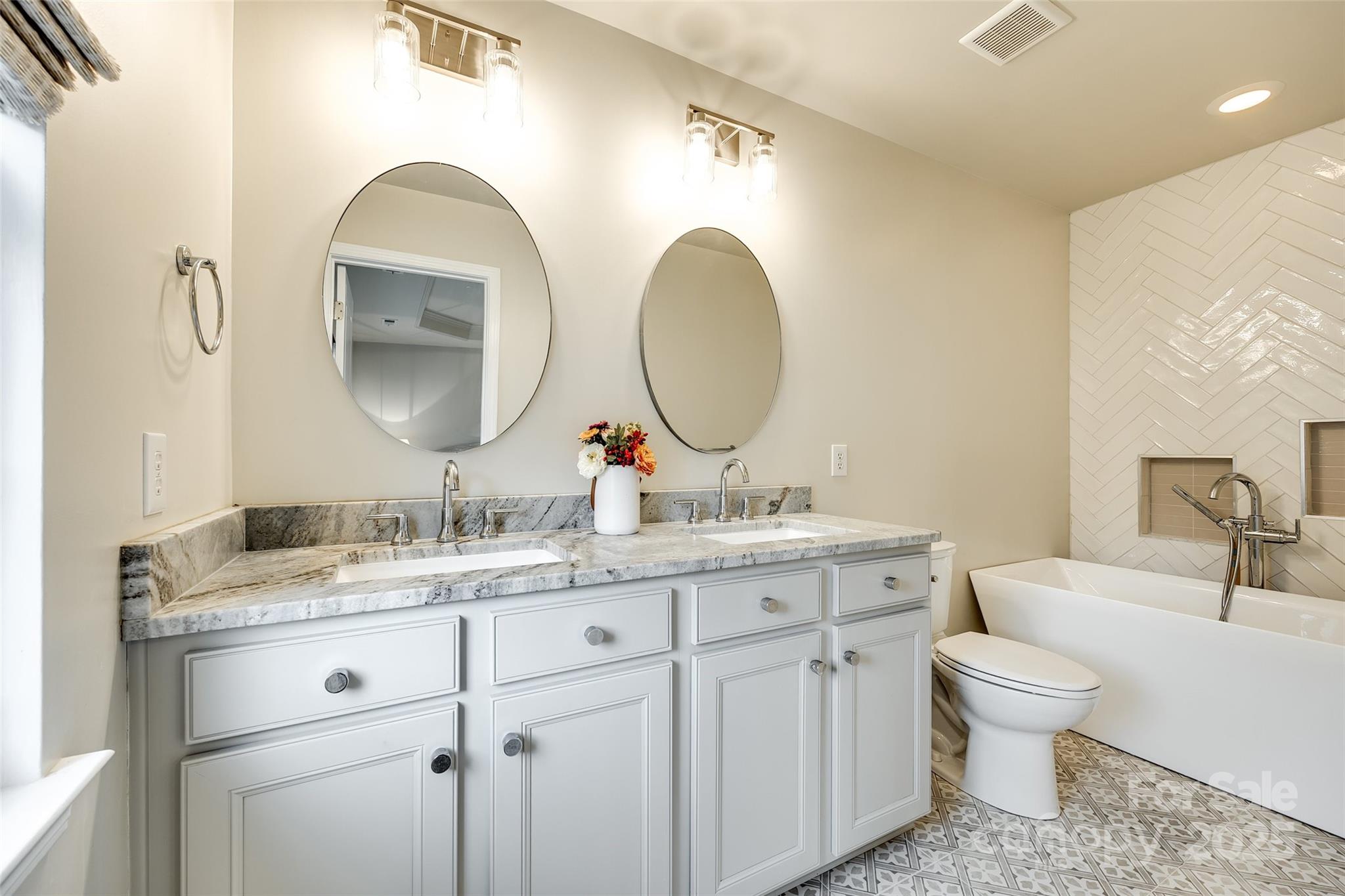 815 Granby Drive Fort Mill, SC 29708 - Photo 19 of 30 a bathroom with a toilet a double vanity sink and a mirror