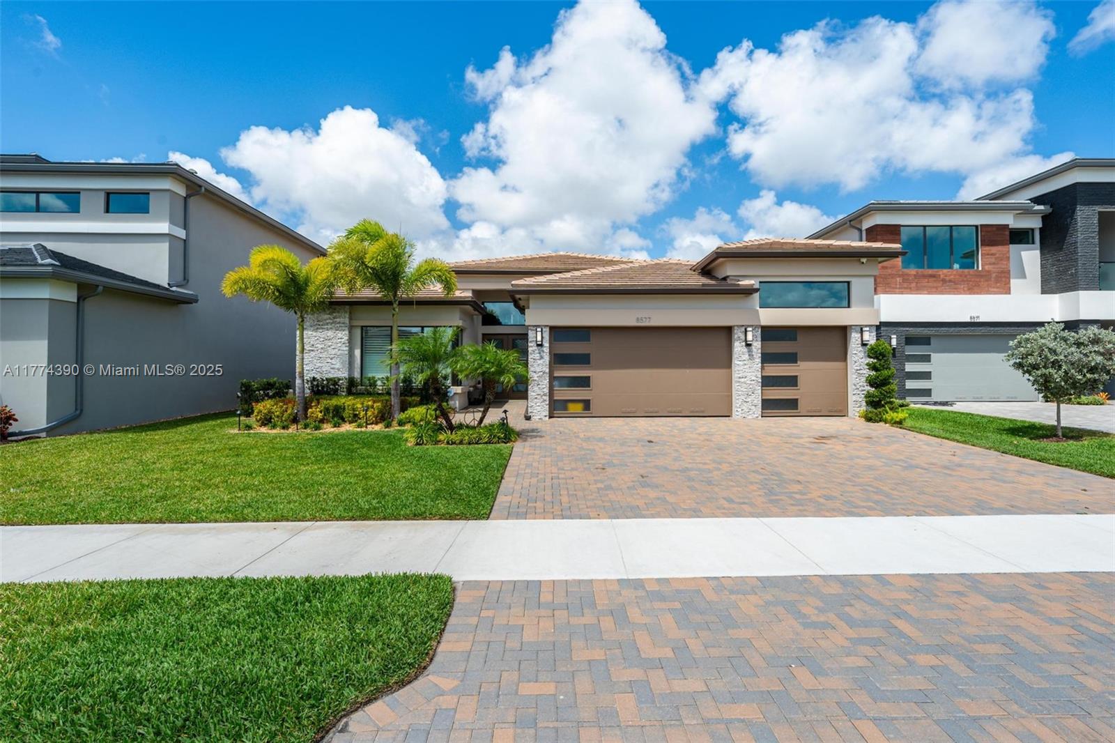 a front view of a house with a yard and a garage