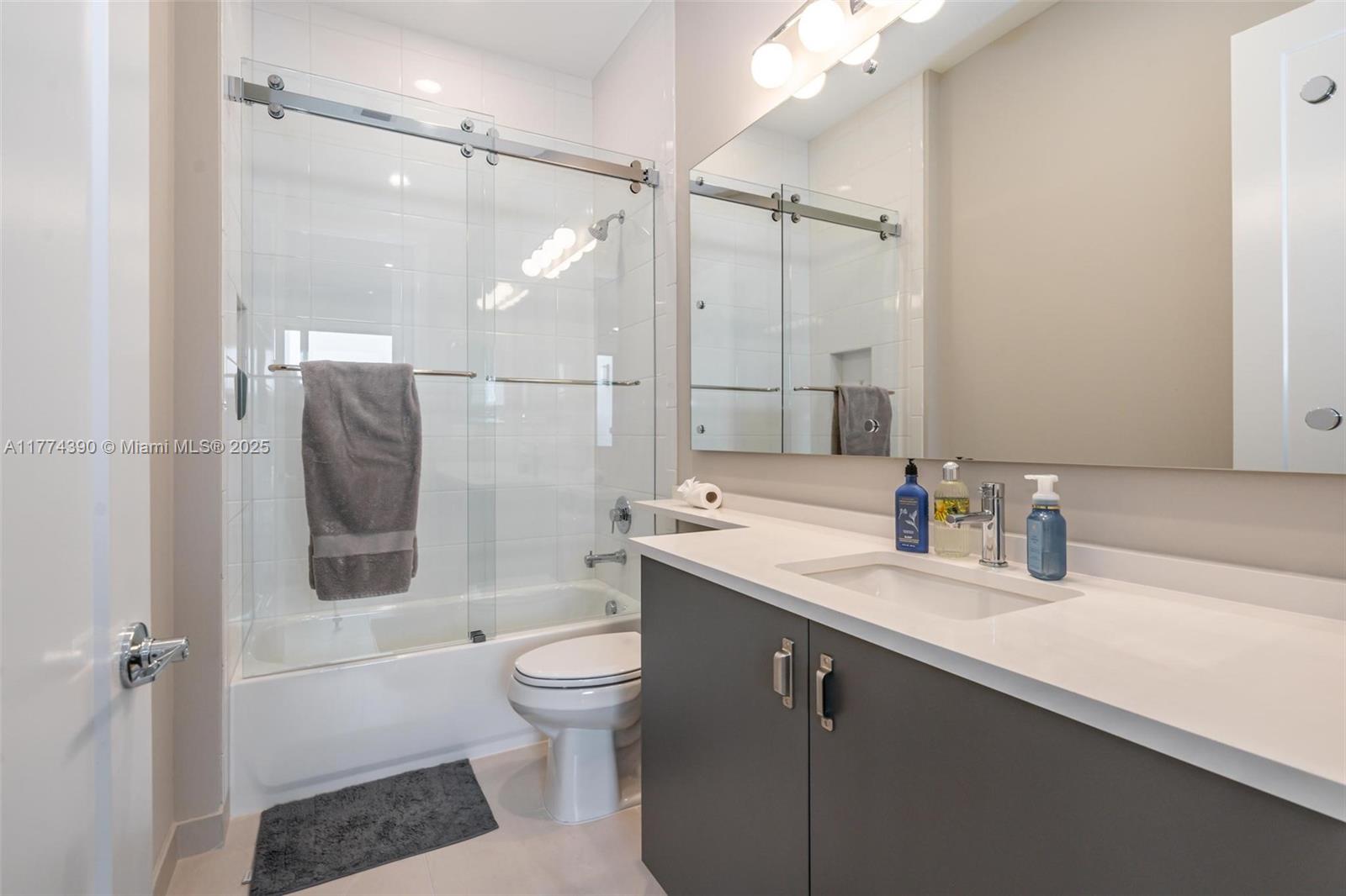 8577 Shoreacres Street Boca Raton, FL 33434 - Photo 36 of 67 a bathroom with a sink a toilet and shower