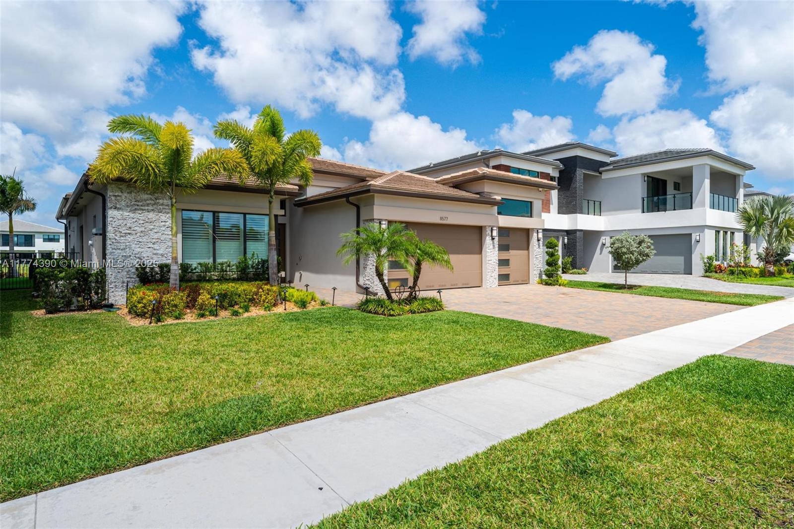 8577 Shoreacres Street Boca Raton, FL 33434 - Photo 5 of 67 a front view of a house with a yard