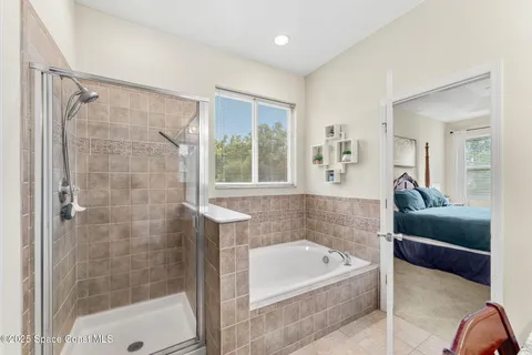 a bathroom with a tub a sink and a shower