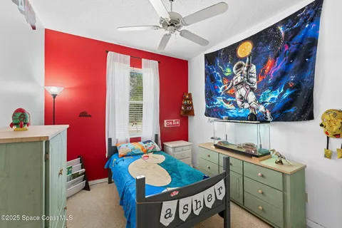 a bed room with furniture and window