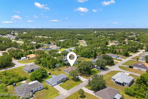 an aerial view of residential houses with outdoor space and river