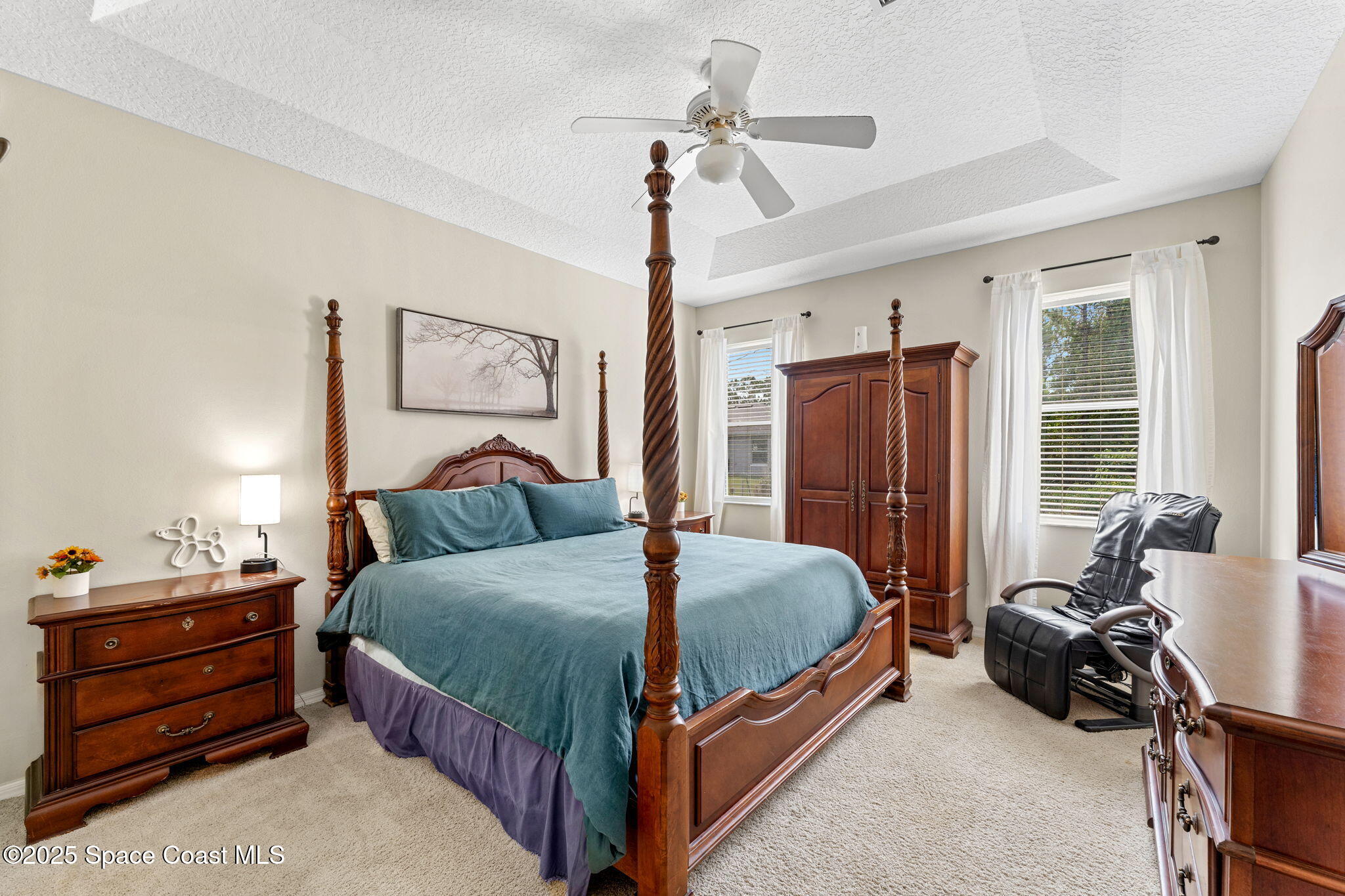 1266 Ragen Road Southeast Palm Bay, FL 32909 - Photo 10 of 28 a bedroom with a bed and a chandelier