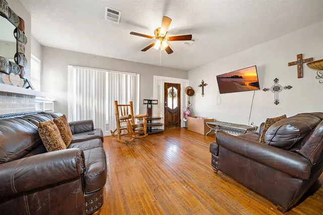 a living room with furniture and wooden floor