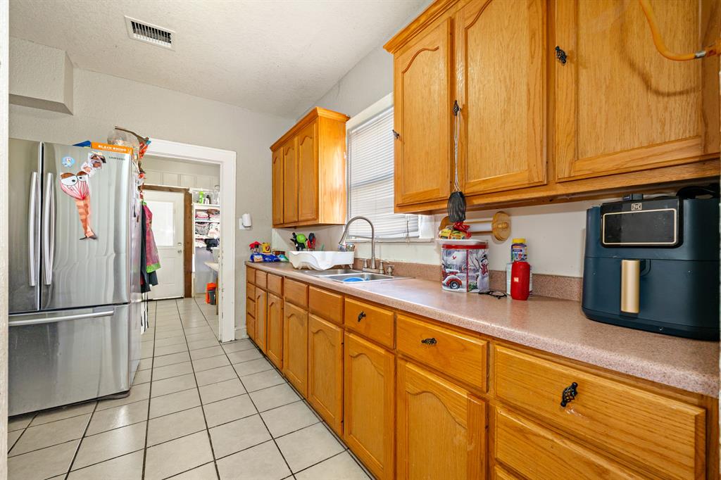 502 North 23rd Street Waco, TX 76707 - Photo 7 of 19 a kitchen with stainless steel appliances granite countertop a refrigerator and a sink