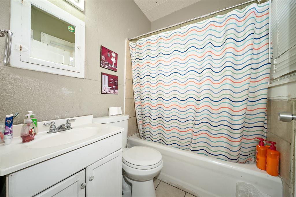 502 North 23rd Street Waco, TX 76707 - Photo 10 of 19 a bathroom with a sink toilet and a shower curtain
