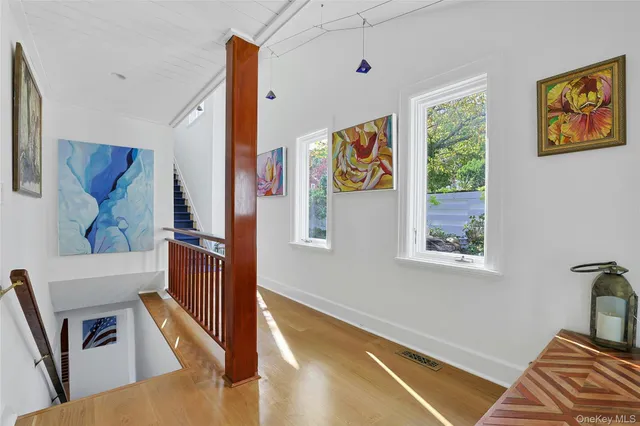 a bedroom with a bed and large windows