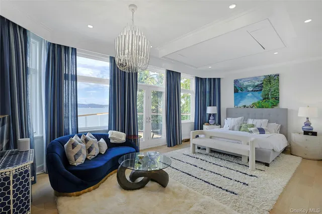 a living room with fireplace furniture and a large window